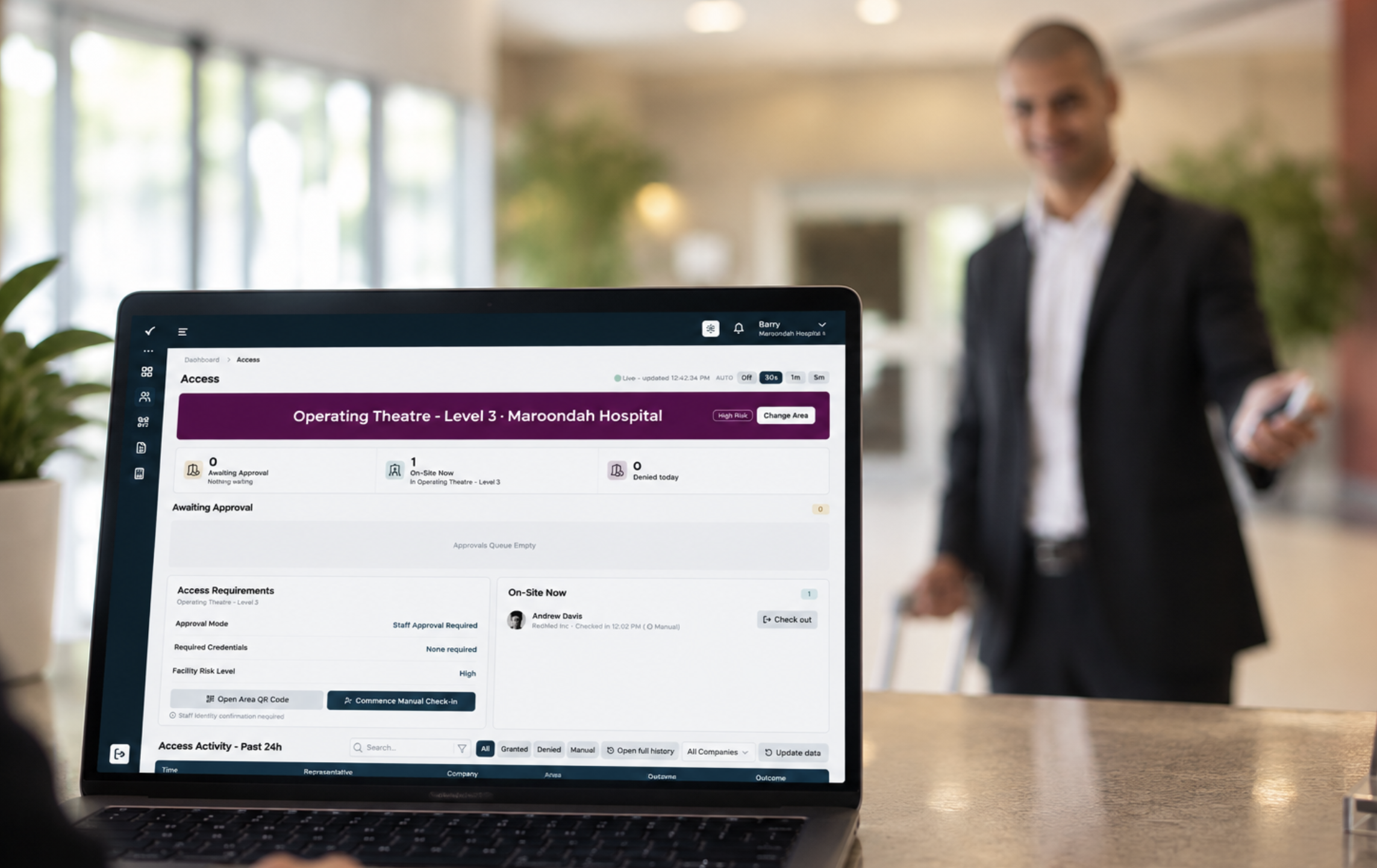 Healthcare facility professional using the OneCredential live access dashboard on a laptop
